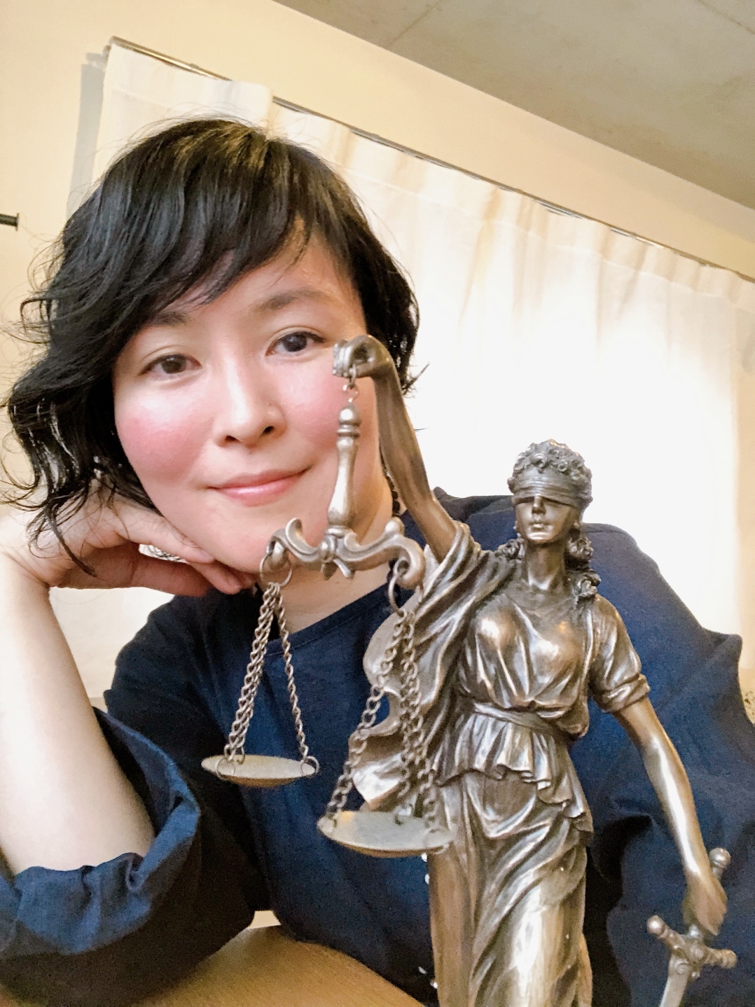 テミス像と主宰の鈴木麻子
